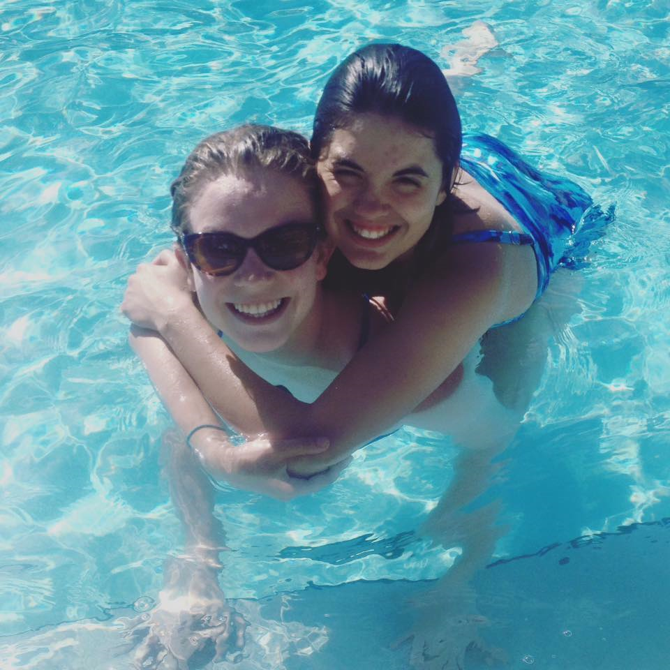 Anastasia Ratcliffe, CHI research analyst, and her sister in a swimming pool.