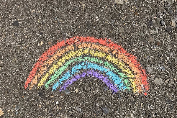 Chalk rainbow painted on asphalt