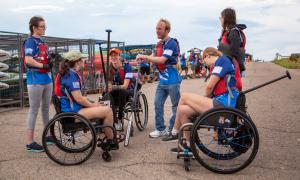 From left, Team Blue athletes Lauren Slack, Liz Mahoney, Alison Rehfus, Frank Kane, Claire Thomas, and Raegan Bowyer prepare to load into the boat during a recent practice.